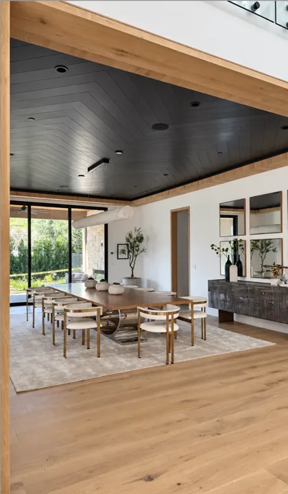 Dining room opening to the garden through wide glass doors