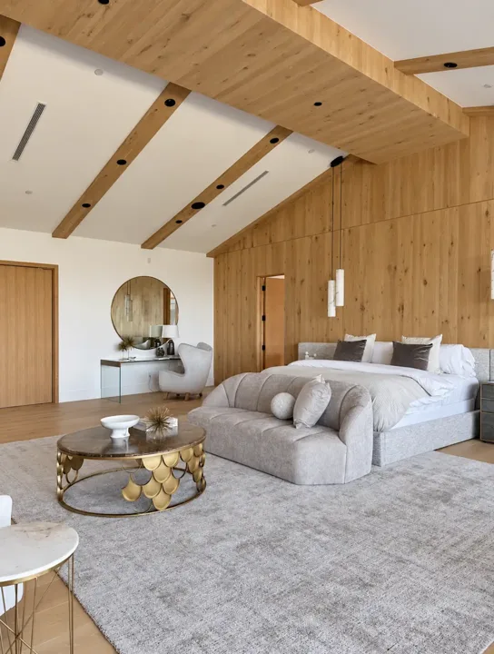 Bedroom with a wood feature wall and exposed ceiling beams