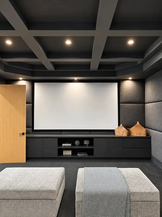 Home cinema with a coffered ceiling and projection screen