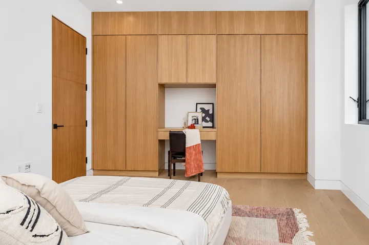 Bedroom with a floor-to-ceiling oak feature wall