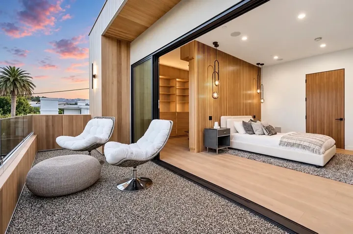 Bedroom opening to a terrace with lounge seating