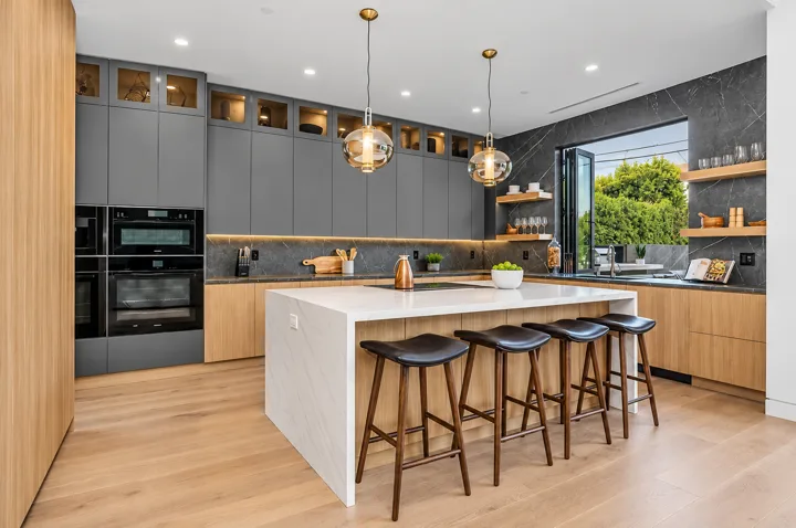 Kitchen island with counter seating beside a corner window