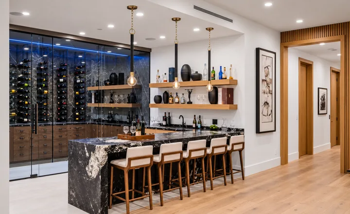 Home bar with upholstered stools and glass-front wine storage