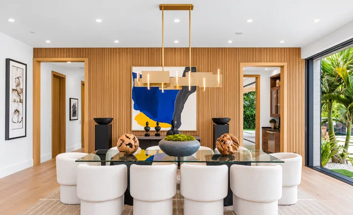 Dining room with curved chairs and colorful artwork