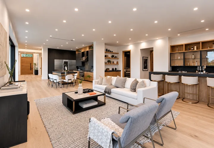 Open-plan living room with oak floors and built-in shelving