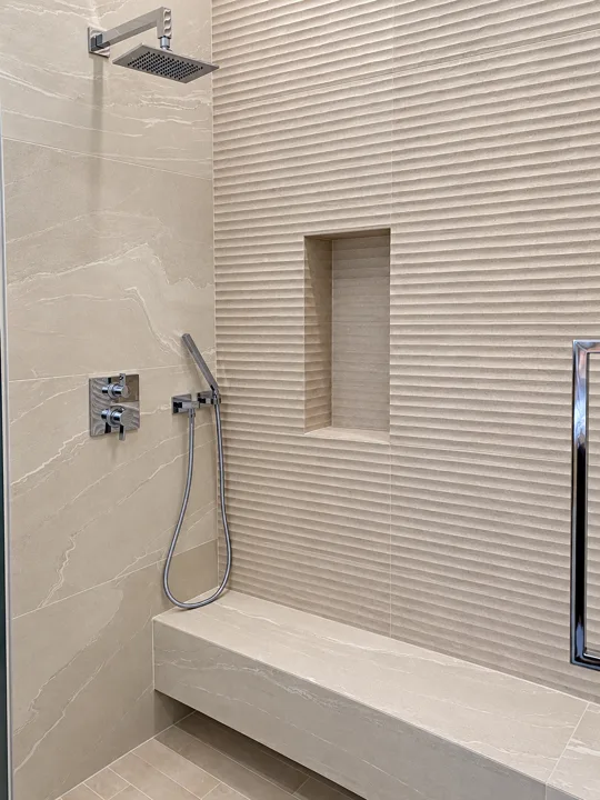 Shower with ribbed tile and a recessed wall niche