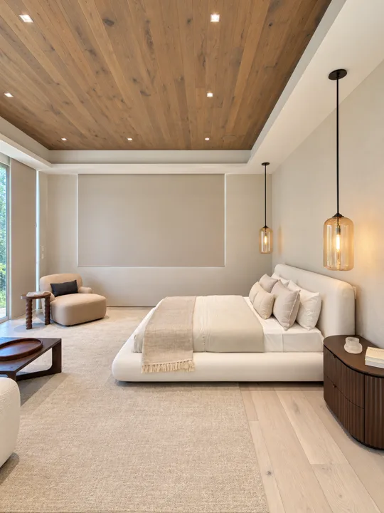 Bedroom with a wood ceiling and pendant bedside lighting