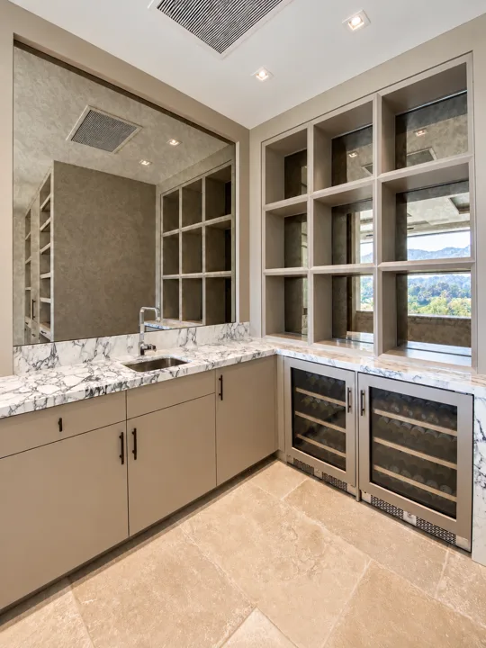 Marble-topped bar with oak wine storage and open shelving