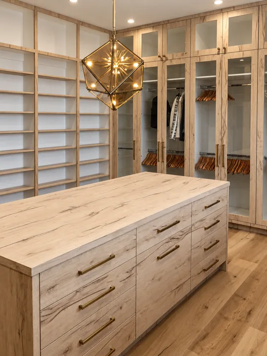 Walk-in closet with open storage and an oak center island