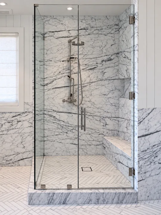 Veined marble shower with black-framed glass