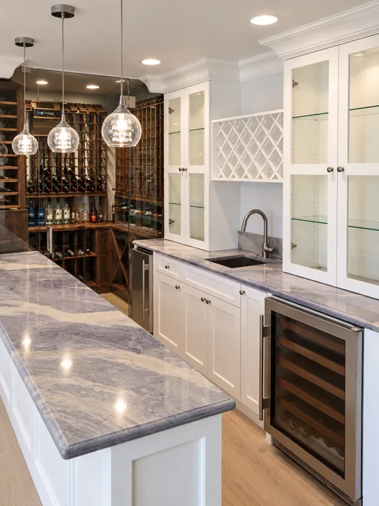 White bar cabinetry with glass doors and a marble countertop