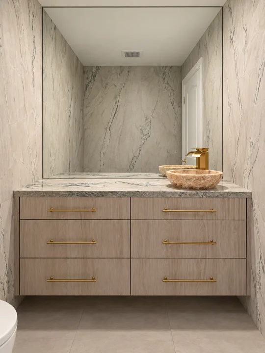 Oak vanity with a veined marble backsplash and brass handles