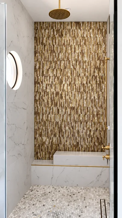 Textured brass-toned tile beside a stone bathroom wall